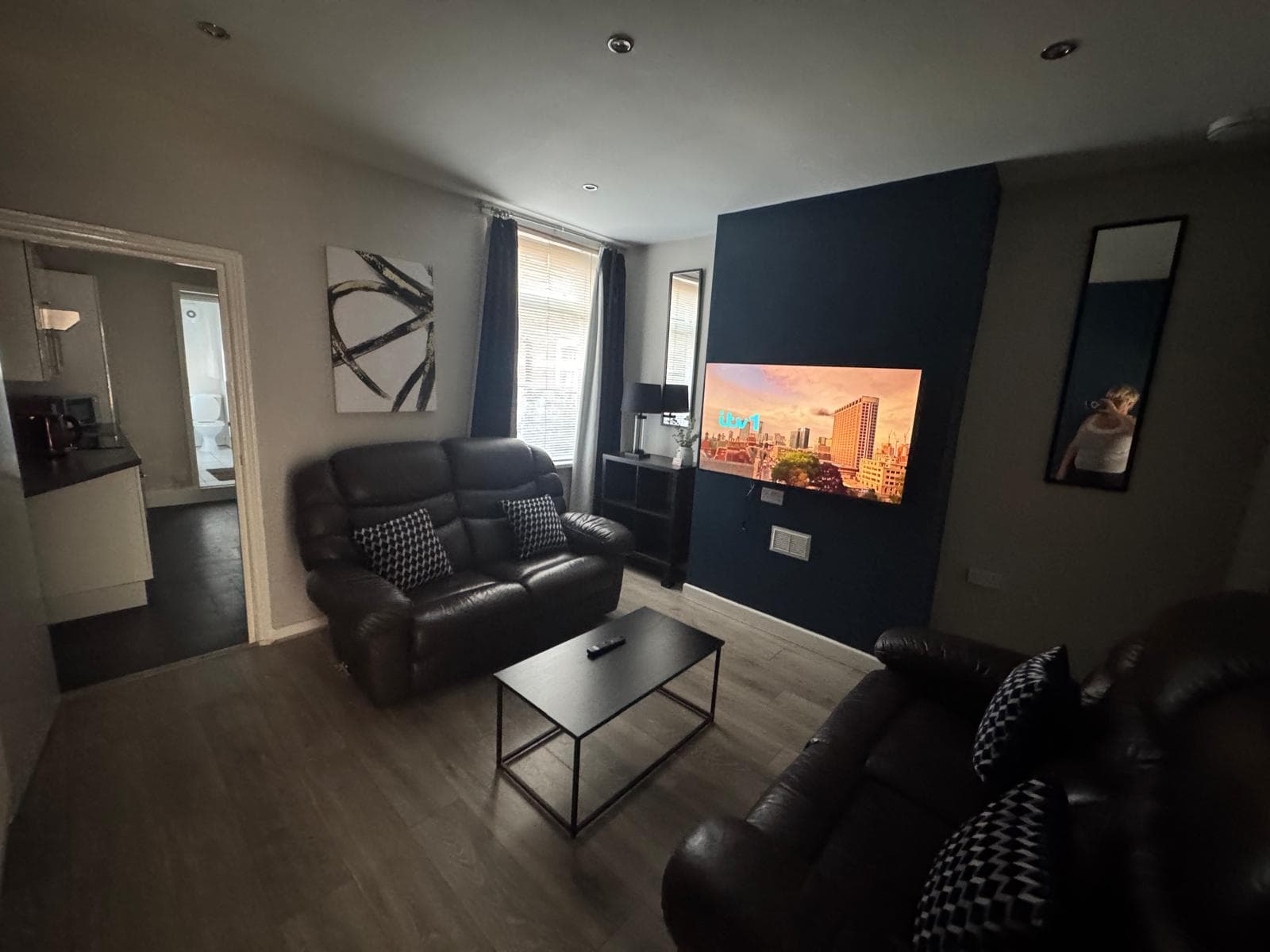 The shared lounge of an HMO student house on Carlton Road, looking through to the ground-floor shower room